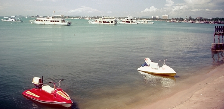 Tourist boats and retro jet skis in Pattaya Bay